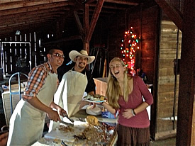 Alejandro and Juanillo serve carnitas to