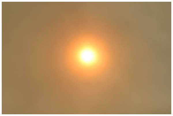 The sun, dimmed by the smoke from the Summit Fire