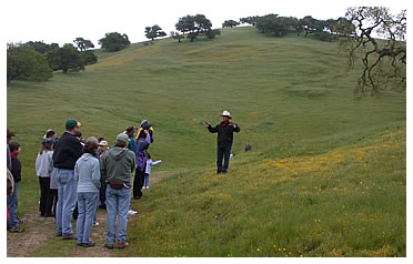 Joe Morris explains his holistic management practices to a group in 2005