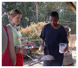 Teens making bread for wood-fired oven