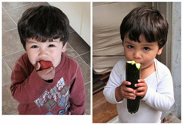 toddler with strawberry, and noshing on a zucchini